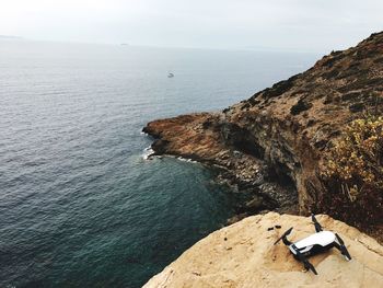 High angle view of rock formation in sea against sky