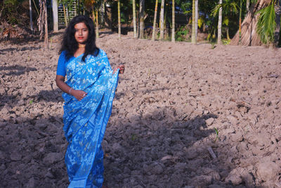 Portrait of woman standing in sunlight