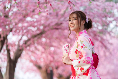 Woman holding cherry blossom