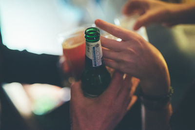 Close-up of woman hand holding bottle