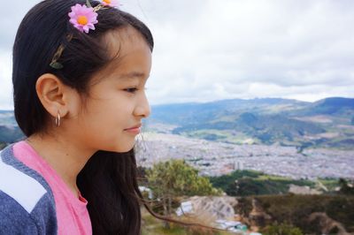 Side view of girl looking at landscape