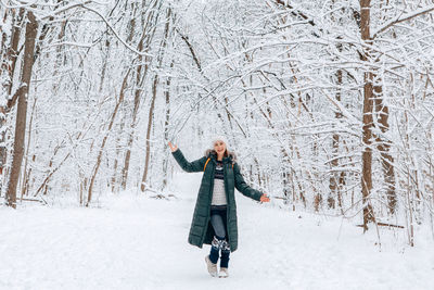 Woman standing on snow covered land