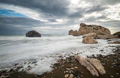 Rocks on beach against sky