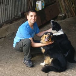 Portrait of woman with dog sitting outdoors