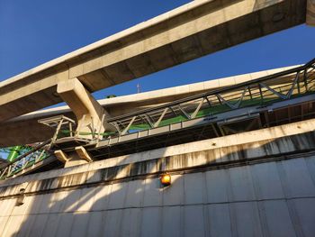 View under the skytrain and walkway connecting to the skytrain station.