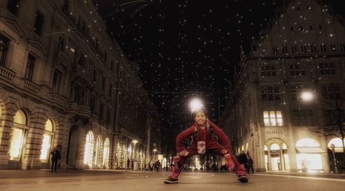 Woman in illuminated building at night