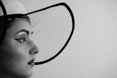 Close-up portrait of woman against sky