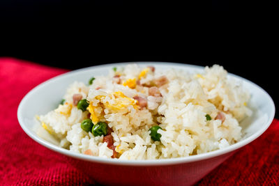 Close-up of rice in bowl against black background