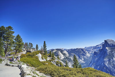Scenic view of snowcapped mountains against clear blue sky