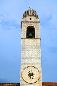 Low angle view of bell tower against sky