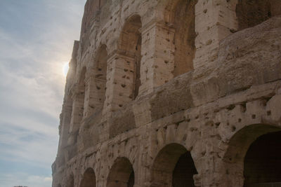 Low angle view of coliseum against sky