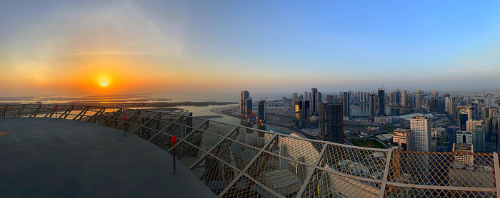 Panoramic view of buildings against sky during sunset