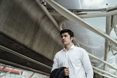 Low angle view of businessman standing in city