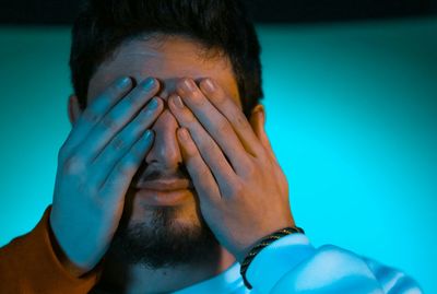 Cropped hands of woman covering man eyes