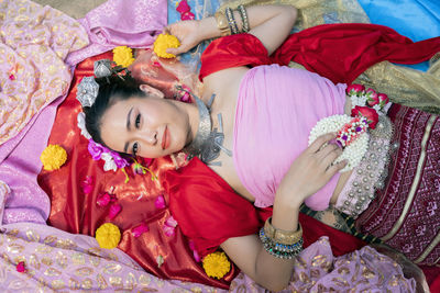 High angle view of woman lying on bed