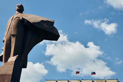 Low angle view of statue against blue sky