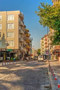 Street amidst buildings in city against sky