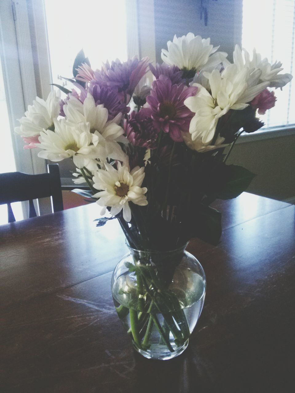 flower, indoors, vase, freshness, fragility, table, home interior, petal, glass - material, flower arrangement, potted plant, flower head, decoration, window, plant, growth, flower pot, white color, window sill, bunch of flowers