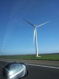 Windmills against blue sky