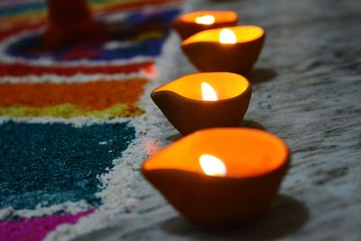 Close-up of lit candle in row