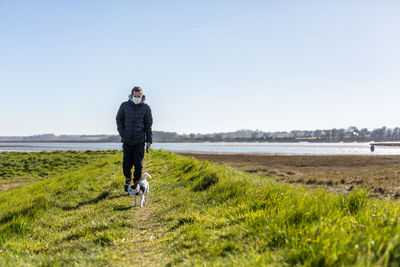 Full length of man standing on land against sky