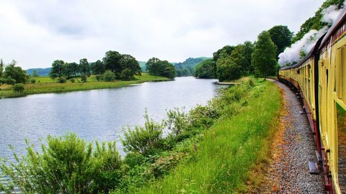 Train passing along river