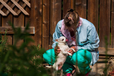 Full length of woman holding dog