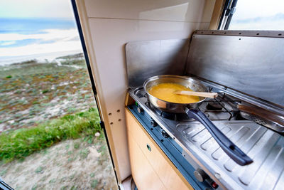 Close-up view of food in saucepan on stove at campervan