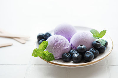 Homemade blueberry ice cream with fresh blueberries. sweet berry summer dessert. concrete background