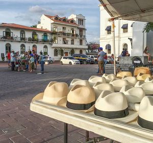 Sun hats arranged for sale at market stall in city