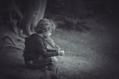 Side view of boy looking at camera