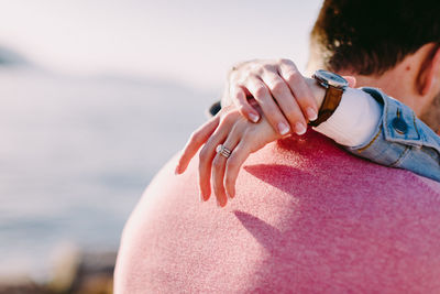 Close-up of woman by sea against sky