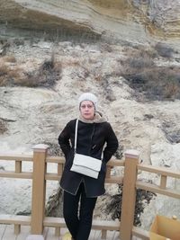 Portrait of woman standing in snow