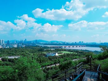 High angle view of trees and buildings against sky