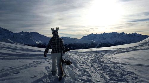 Scenic view of snow covered mountains against sky