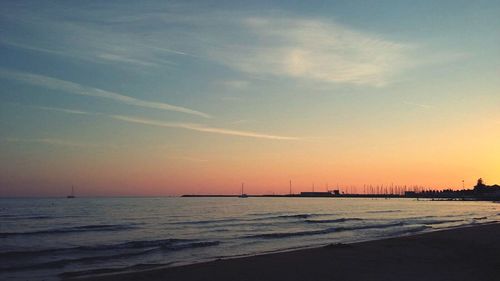 View of calm beach at sunset