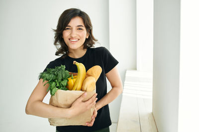 Portrait of smiling young woman holding ice cream