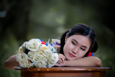 Portrait of young woman with flowers