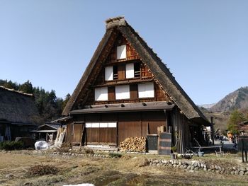 Old house on field against clear sky