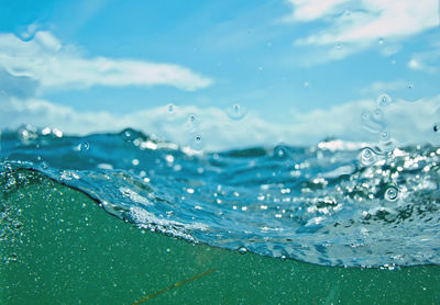 Close-up of water splashing against blue sea