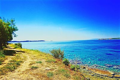 Scenic view of sea against clear blue sky