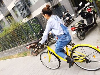 Man riding bicycle on city street