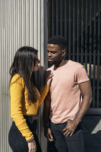 Young couple standing on woman outdoors