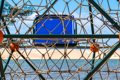 Low angle view of metallic structure against blue sky