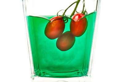 Close-up of fresh fruits in glass over white background