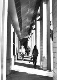 Rear view of people walking on building