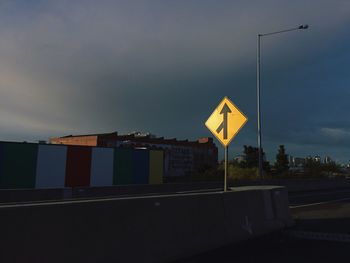 Street light against cloudy sky