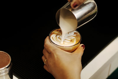 Close-up of hand holding coffee cup