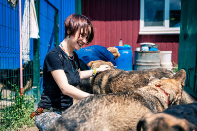 Side view of man playing with dog