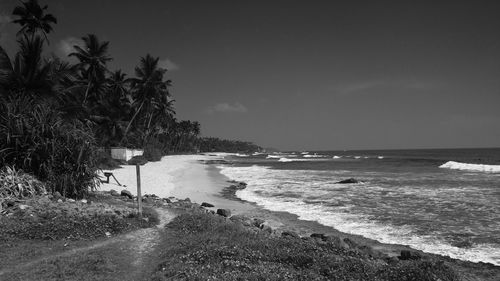 View of calm beach against clear sky